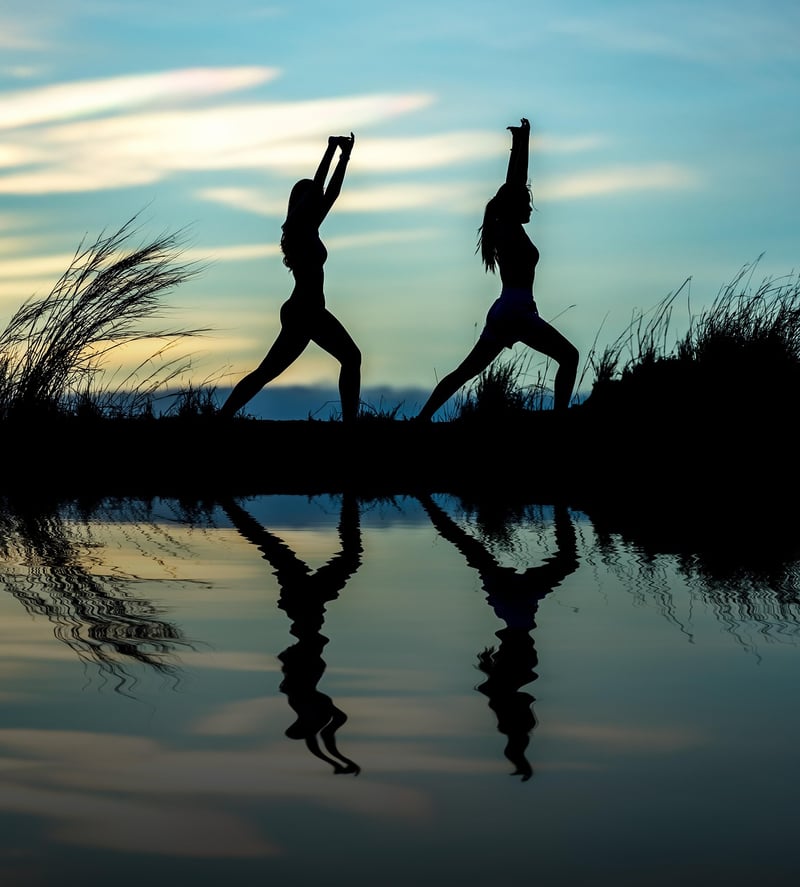 Woman practicing yoga at sunset